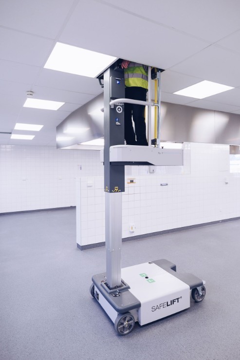 Safelift mast lift at full height accessing the ceiling